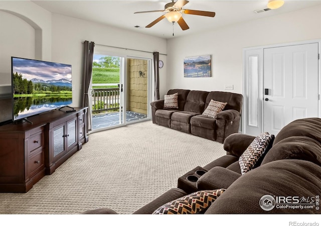 living room featuring light colored carpet and ceiling fan