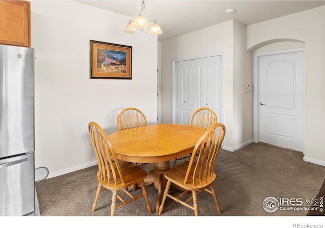 dining room with baseboards and dark carpet