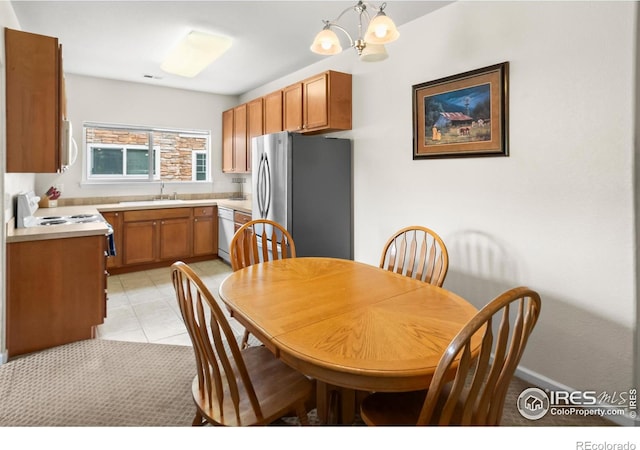 dining space featuring a chandelier and light tile patterned flooring