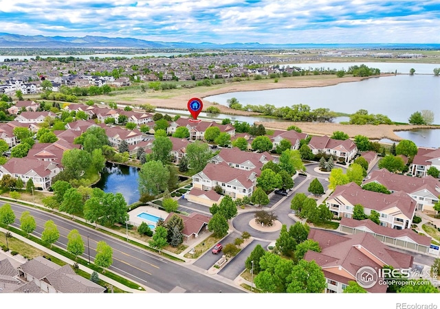 aerial view of residential area featuring a water and mountain view