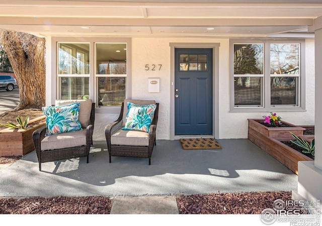 527 S Bryan Ave, Fort Collins, CO 80521 - view of exterior entry featuring stucco siding and covered porch