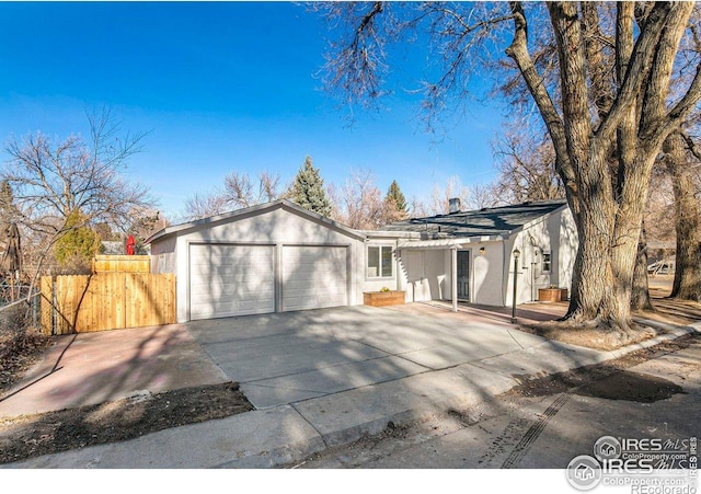 527 S Bryan Ave, Fort Collins, CO 80521 - ranch-style house featuring an attached garage, fence, concrete driveway, and stucco siding
