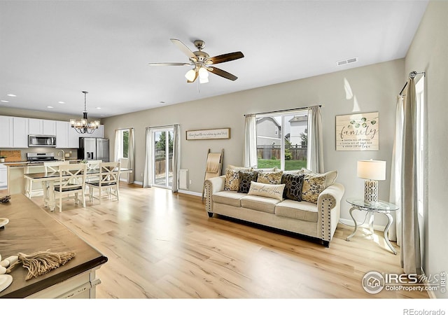 6008 Sandstone Cir, Frederick, CO 80516 - living room with a ceiling fan, a chandelier, light wood-type flooring, recessed lighting, and baseboards