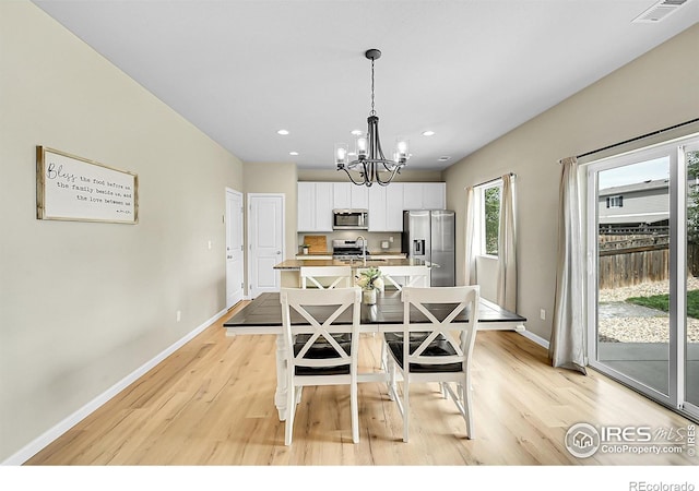6008 Sandstone Cir, Frederick, CO 80516 - dining space featuring a chandelier, light wood-style flooring, baseboards, and recessed lighting