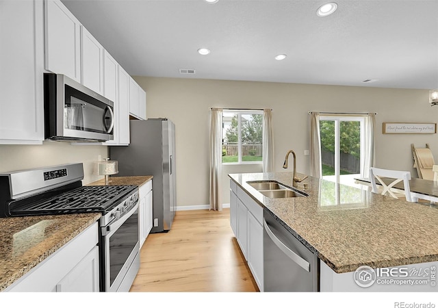 6008 Sandstone Cir, Frederick, CO 80516 - kitchen featuring appliances with stainless steel finishes, a sink, light wood-type flooring, recessed lighting, and white cabinets