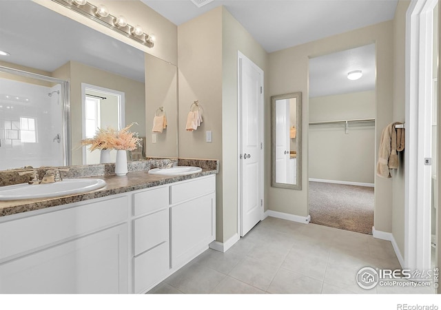6008 Sandstone Cir, Frederick, CO 80516 - full bath featuring double vanity, a shower stall, tile patterned floors, a spacious closet, and baseboards