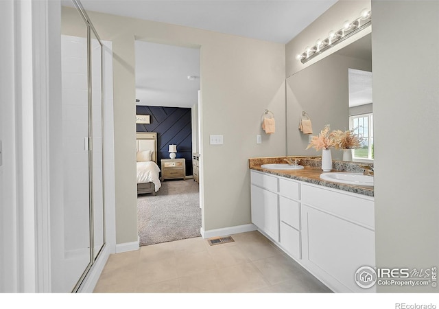 6008 Sandstone Cir, Frederick, CO 80516 - bathroom featuring ensuite bathroom, double vanity, baseboards, a shower stall, and tile patterned floors