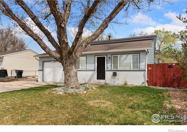312 21st Avenue Ct, Greeley, CO 80631 - view of front of house featuring an attached garage, brick siding, and driveway
