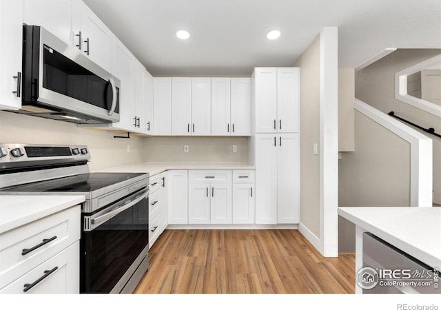 312 21st Avenue Ct, Greeley, CO 80631 - kitchen with stainless steel appliances, light wood-type flooring, light countertops, white cabinetry, and recessed lighting