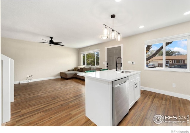 312 21st Avenue Ct, Greeley, CO 80631 - kitchen with a sink, dishwasher, wood finished floors, white cabinetry, and recessed lighting