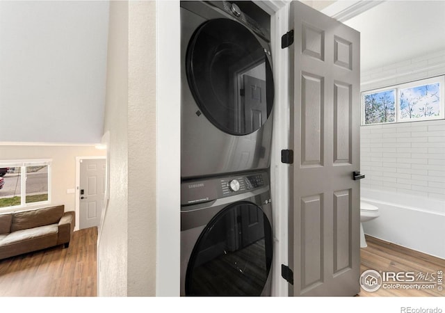 312 21st Avenue Ct, Greeley, CO 80631 - laundry room with stacked washer / dryer and wood finished floors