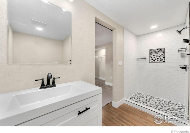 312 21st Avenue Ct, Greeley, CO 80631 - bathroom featuring a shower stall, wood finished floors, vanity, recessed lighting, and a walk in closet