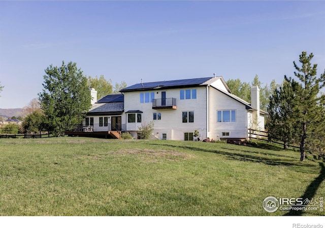4932 Valkyrie Dr, Boulder, CO 80301 - back of property with a chimney, solar panels, and a wooden deck