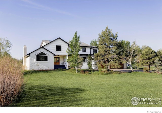 4932 Valkyrie Dr, Boulder, CO 80301 - view of front facade featuring a front lawn, a chimney, and french doors