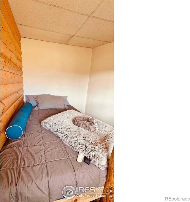 867 Windy Ridge Rd, Red Feather Lakes, CO 80545 - bedroom featuring a drop ceiling and log walls