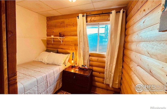 867 Windy Ridge Rd, Red Feather Lakes, CO 80545 - bedroom featuring rustic walls and wooden walls