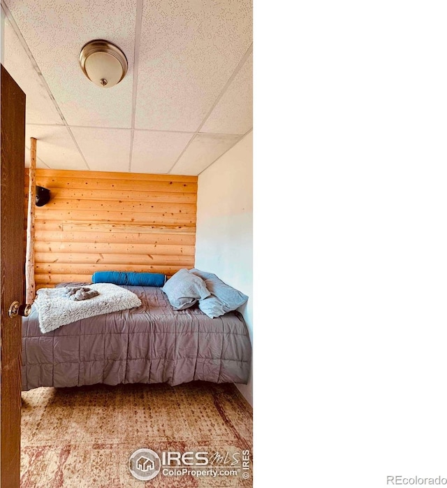 867 Windy Ridge Rd, Red Feather Lakes, CO 80545 - bedroom featuring rustic walls and a paneled ceiling