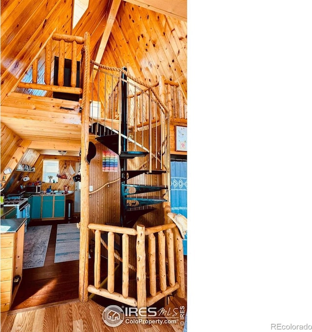 867 Windy Ridge Rd, Red Feather Lakes, CO 80545 - staircase with lofted ceiling, wood finished floors, and wooden walls