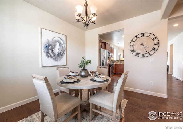 1358 14th Ave, Longmont, CO 80501 - dining area featuring a chandelier, dark wood-style flooring, and baseboards