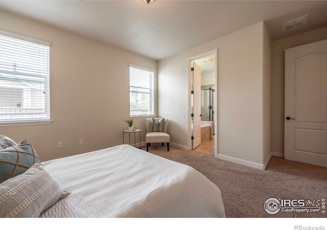 1358 14th Ave, Longmont, CO 80501 - carpeted bedroom featuring baseboards and connected bathroom