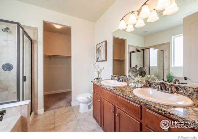 1358 14th Ave, Longmont, CO 80501 - bathroom with a stall shower, a walk in closet, double vanity, and tile patterned floors