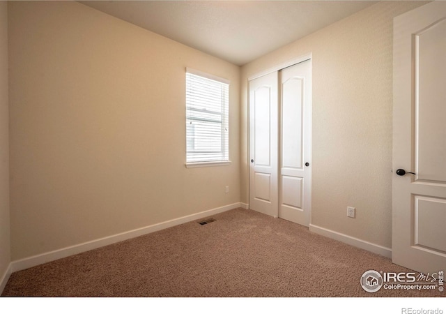 1358 14th Ave, Longmont, CO 80501 - unfurnished bedroom featuring carpet, baseboards, and a closet