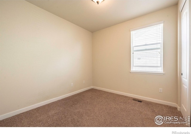 1358 14th Ave, Longmont, CO 80501 - carpeted empty room featuring baseboards