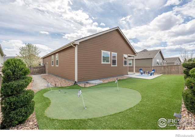 1358 14th Ave, Longmont, CO 80501 - back of property featuring a putting area, a patio area, and a fenced backyard