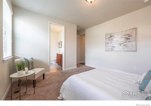 1358 14th Ave, Longmont, CO 80501 - bedroom featuring light carpet, multiple windows, ensuite bathroom, and baseboards