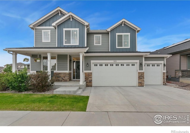 1203 Cabot Ct, Fort Collins, CO 80526 - craftsman-style house featuring board and batten siding, stone siding, covered porch, and an attached garage