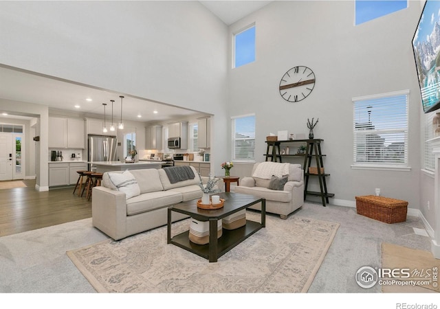 1203 Cabot Ct, Fort Collins, CO 80526 - carpeted living room featuring baseboards, a high ceiling, and recessed lighting