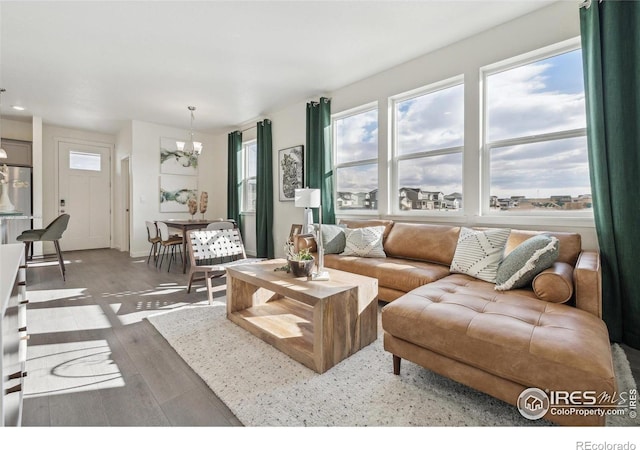 18722 E 99th Ave, Commerce City, CO 80022 - living room featuring a chandelier and wood finished floors