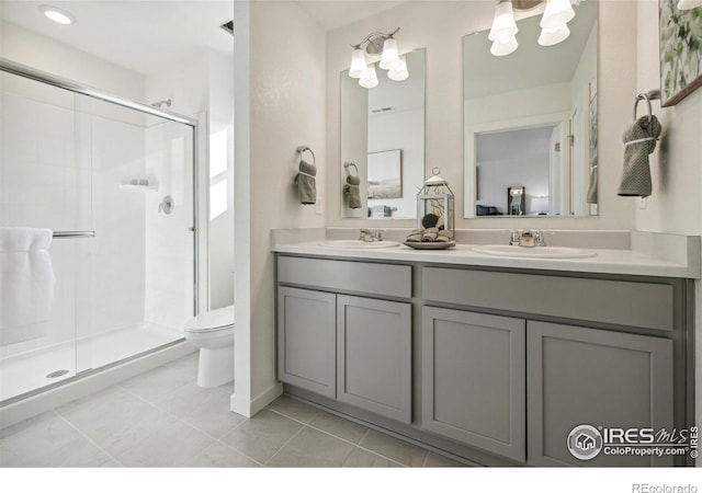 18722 E 99th Ave, Commerce City, CO 80022 - bathroom featuring a stall shower, toilet, double vanity, a chandelier, and tile patterned flooring