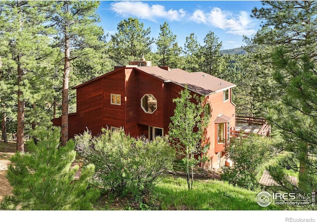 1101 Peakview Cir, Boulder, CO 80302 - view of front facade featuring a chimney and a wooden deck
