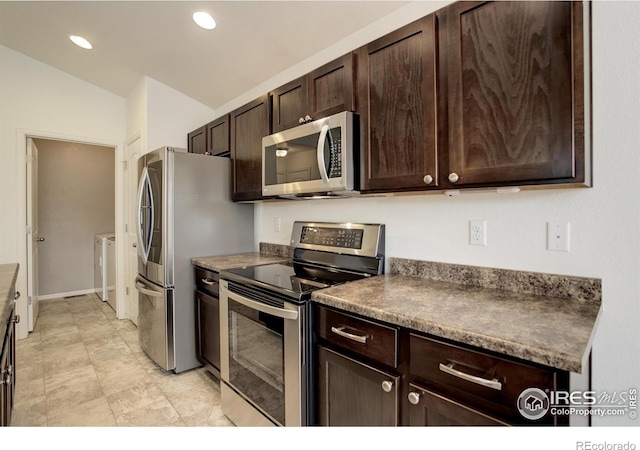 1540 Murrlet St, Berthoud, CO 80513 - kitchen featuring stainless steel appliances, washing machine and dryer, dark brown cabinets, vaulted ceiling, and recessed lighting