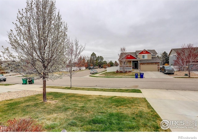 1540 Murrlet St, Berthoud, CO 80513 - view of grassy yard featuring driveway and a garage
