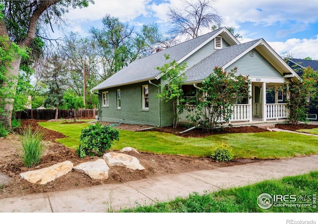 322 Vivian St, Longmont, CO 80501 - view of front of home with a porch, a shingled roof, and brick siding