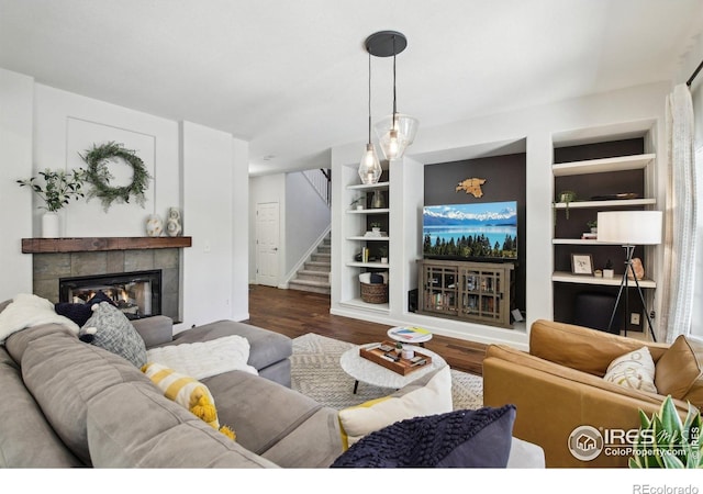 4109 Frederick Cir, Longmont, CO 80503 - living area featuring stairway, dark wood finished floors, built in features, and a tile fireplace