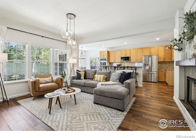 4109 Frederick Cir, Longmont, CO 80503 - living area with a glass covered fireplace, dark wood finished floors, recessed lighting, and baseboards