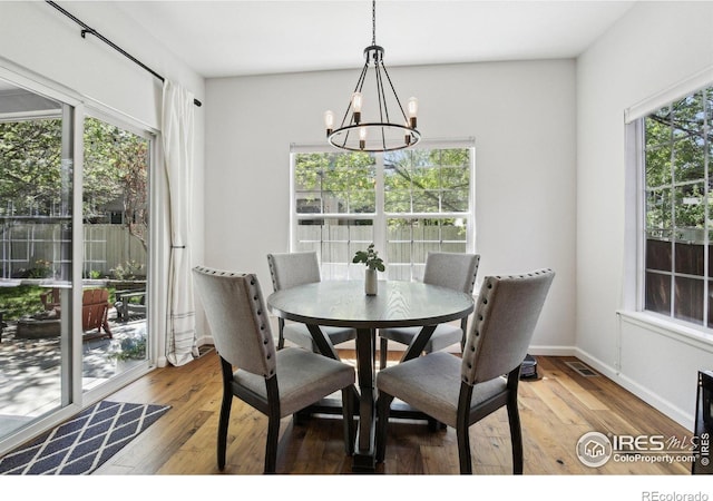 4109 Frederick Cir, Longmont, CO 80503 - dining space with a chandelier, light wood-style flooring, and baseboards