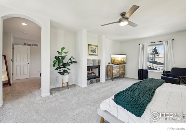 4109 Frederick Cir, Longmont, CO 80503 - bedroom featuring arched walkways, carpet floors, a high end fireplace, baseboards, and recessed lighting
