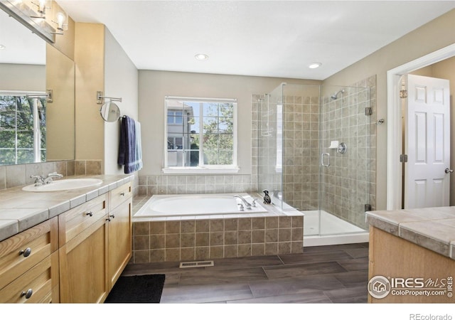4109 Frederick Cir, Longmont, CO 80503 - full bath with plenty of natural light, a shower stall, vanity, a bath, and recessed lighting