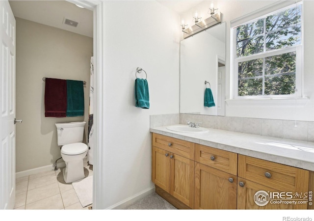 4109 Frederick Cir, Longmont, CO 80503 - bathroom featuring toilet, vanity, baseboards, and tile patterned floors
