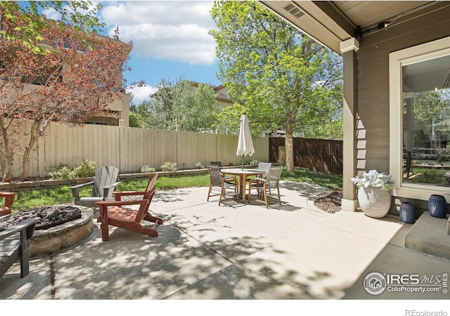 4109 Frederick Cir, Longmont, CO 80503 - fenced backyard featuring an outdoor fire pit, outdoor dining area, and a patio area