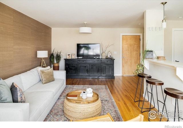 1201 Balsam Ave Unit 302, Boulder, CO 80304 - living room with wood finished floors, an accent wall, and baseboards