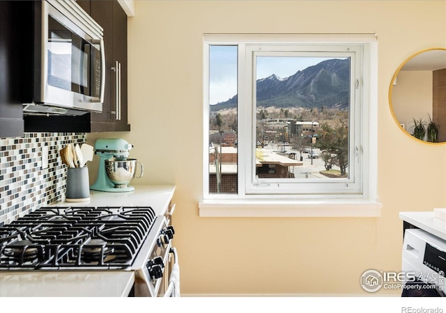 1201 Balsam Ave Unit 302, Boulder, CO 80304 - kitchen with appliances with stainless steel finishes, a mountain view, decorative backsplash, and light countertops