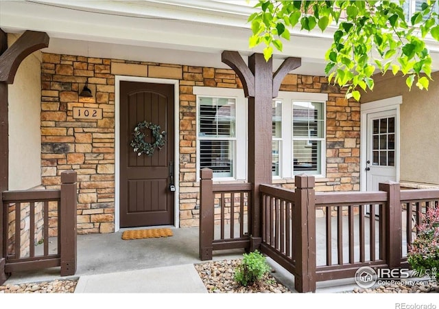 5850 Dripping Rock Ln Unit G 102, Fort Collins, CO 80528 - view of exterior entry with a porch and stone siding