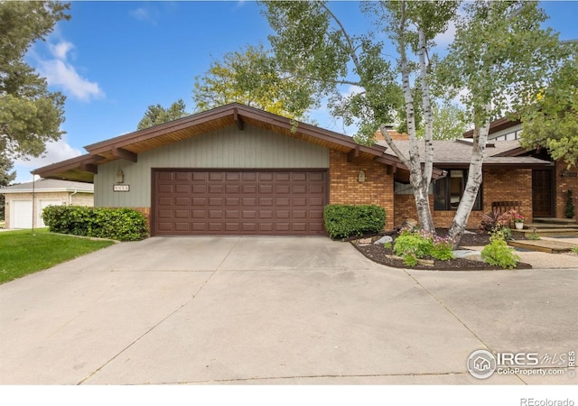 4456 W Pioneer Dr, Greeley, CO 80634 - mid-century home with brick siding, a garage, and driveway