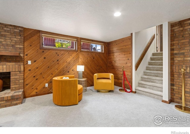 4456 W Pioneer Dr, Greeley, CO 80634 - sitting room with carpet flooring, baseboards, a textured ceiling, stairway, and wooden walls