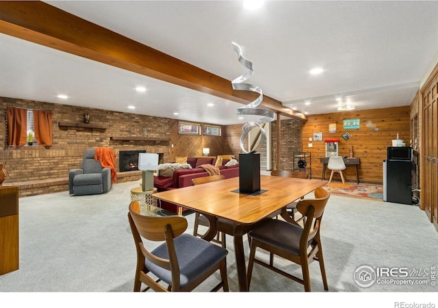 4456 W Pioneer Dr, Greeley, CO 80634 - carpeted dining room featuring a fireplace, recessed lighting, wood walls, and brick wall